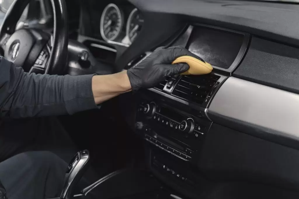 estética automotiva: profissional limpando o interior carro